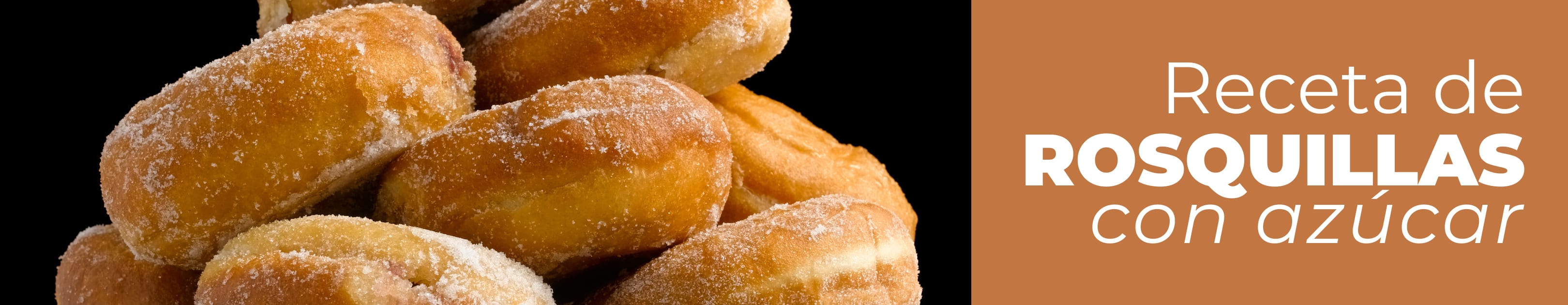 Sobre la encimera de una cocina se puede ver un primer plano de unas rosquillas borrachas espolvoreadas con azúcar al lado de los ingredientes para prepararlas: aceite, anís, azúcar, levadura y harina de trigo.